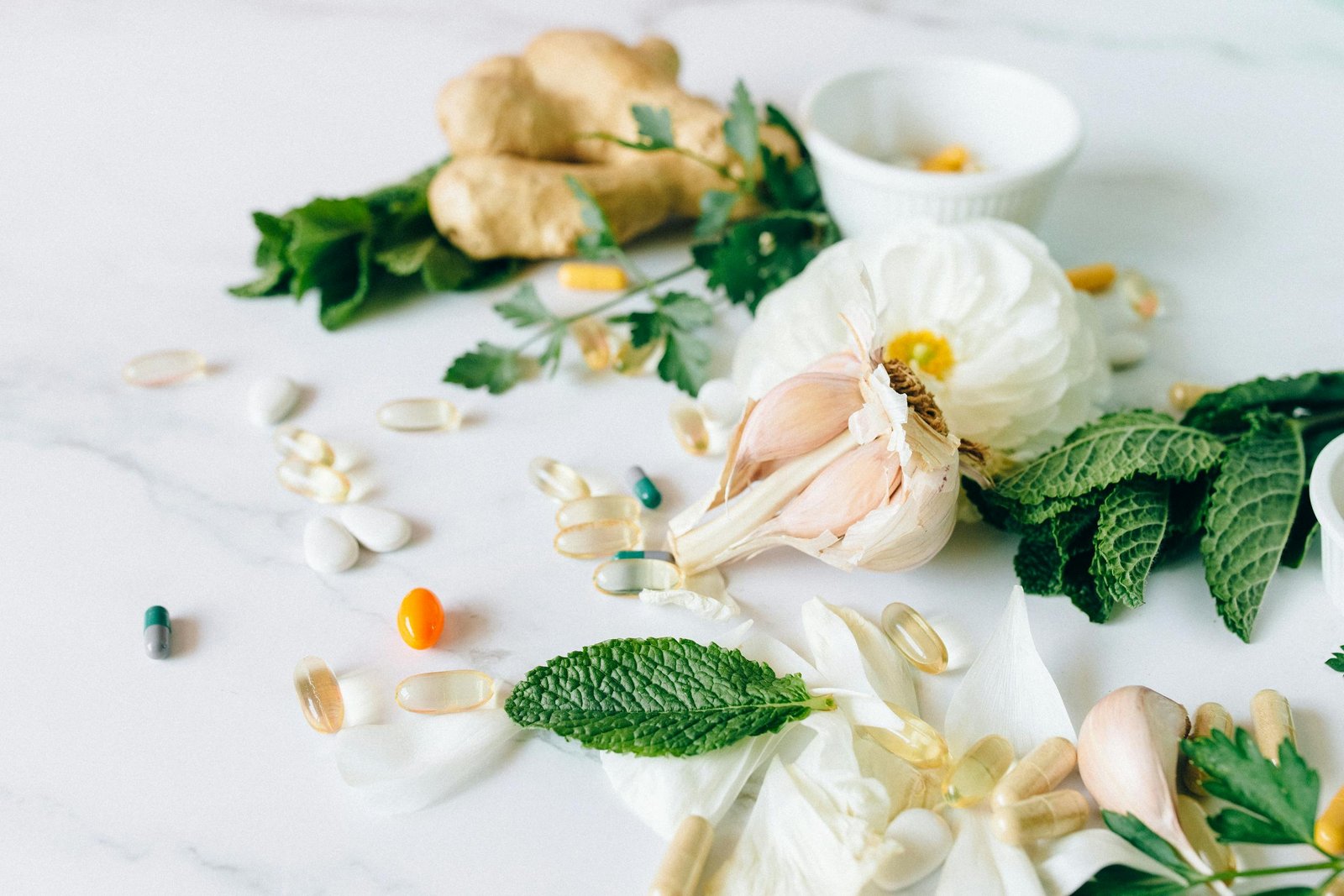 A flat lay of various herbal remedies and vitamin supplements, featuring natural herbs and capsules.